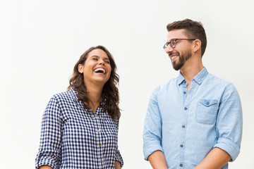 positive funny guy making his girlfriend laugh. young woman in casual and man in glasses in glasses 