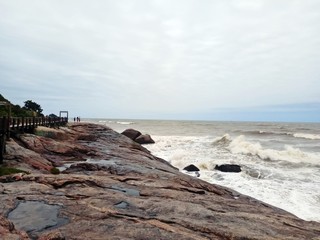 Rocks, sea and a bridge.