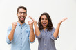 © Mangostar - Happy excited couple rejoicing at good news, making winner gestures, celebrating success. Young woman in casual and man in glasses standing isolated over white background. Good news concept