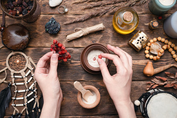 Canvas Print - Witch doctor is preparing a magic potion on her table.