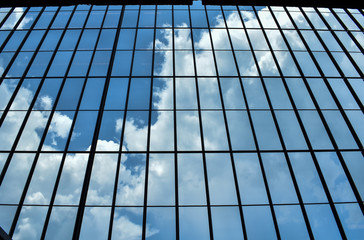 reflection of sky in windows of modern building