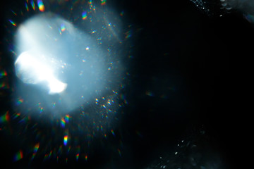 Aufkleber - Light over black background. Easy to add overlay or screen filter over photos. Abstract sun burst with digital lens flare background. Gleams rounded and hexagonal shapes, rainbow halo.
