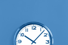 Top Of Big Plain Wall Clock On Trending Pastel Blue Background. Ten O'clock. Close Up With Copy Space, Time Management Or School Concept And Summer Or Winter Time Change, Opening Hours