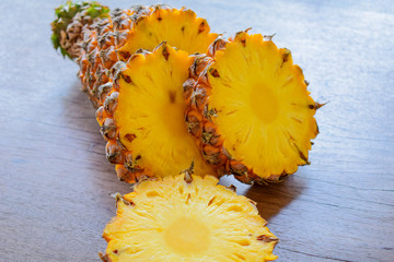 Sliced pineapples on the wooden table