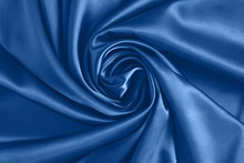 Close Up Of Ripplesin Shape Of Rose Flower In Blue Silk Fabric. Satin Textile Background.