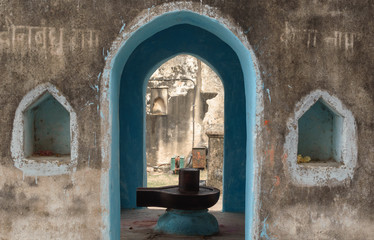 Sticker - Orchha, Madhya Pradesh/India - March 14 2019: A linga inside a shrine dedicated to the Hindu God Shiva at the Raja Mahal. The walls are decorated with niches and mantras are scribbled in Sanskrit.