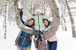© Evgeniy Kalinovskiy - family-mother and two daughters having fun on the background of snow and forest. Winter entertainment