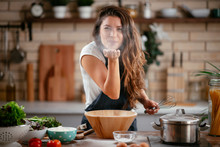 Young Woman In Kitchen. Beautiful Woman Playing With Flour.