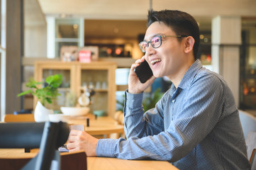 Portrait of handsome asian man using mobile smartphone