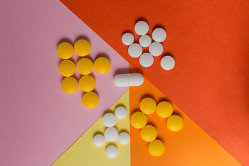 colorful pills and drugs in close up.assorted pills and capsules in medicine. drugs of various kinds and different colors. Medicine on yellow background