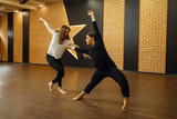 Two contemporary dance performers poses in studio