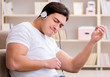 © Elnur - Young man student listening to music at home