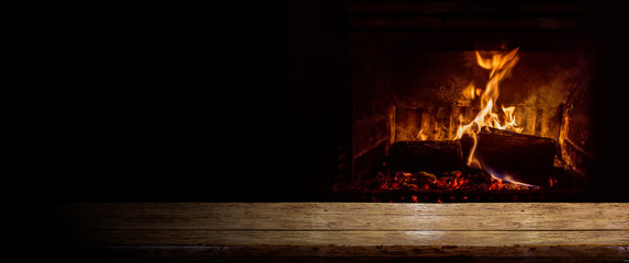 Empty table with burning fire