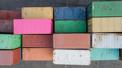 Top down view of colorful containers piles in port container terminal, industrial cargo harbor