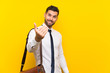 © luismolinero - Handsome businessman over isolated yellow background inviting to come