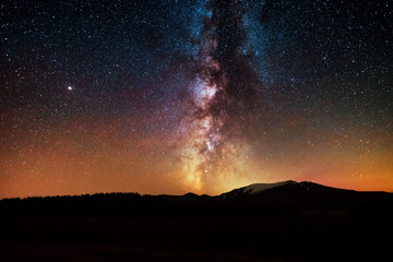 Wall Mural - the bright milky way galaxy on the starrry sky over the mountains. night landsckape. astronomical ba