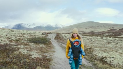 mother and child hiking in norway travel family woman with baby carrier healthy lifestyle vacation a