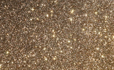 gold sparkle glitter Christmas festive background, texture. Xmas abstract backgrop with copy space.