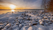 stone pyramids in the snow on the shore of Lake Ladoga in Karelia on a sunny winter day