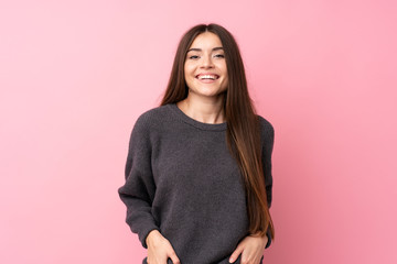 Wall Mural - Young woman over isolated pink background laughing