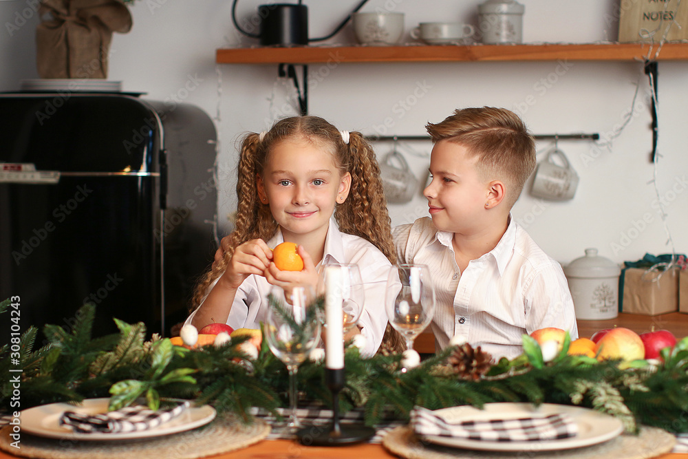 Boy and girl celebrate New Year, drink juice, eat fruit and make wishes ...