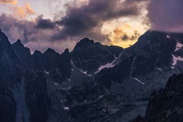  Dramatic sunset over a moutain alpine like landscape of High Tatras, Slovakia. Rugged rocky mountains during spectacular sunset or sunrise. High peaks of Tatra mountains.