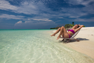 Young gorgeous woman in bikini on a tropical island