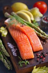 Fresh raw salmon fillet steak with vegetables and ingredients prepared for cooking