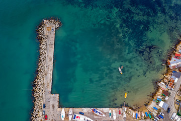 Wall Mural - Top view from drone to the pier and the marina with boats and yachts. Sea landscape with fishing houses from above