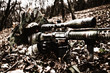 © Getmilitaryphotos - Army sniper hiding on ground in forest leaves
