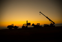 Abstract Industrial Background With Construction Crane Silhouette Over Amazing Sunset Sky. Mobile Crane Against The Evening Sky. Industrial Skyline. Selective Focus