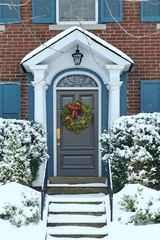 Wall Mural - Front door of snow covered house with Christmas wreath