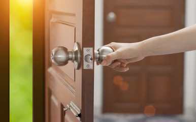 Wall Mural - Women hand open door knob or opening the door,grand opening,Close up hand open door.