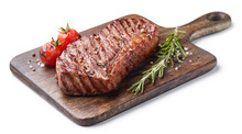 Grilled beef steak on wooden board isolated on white background with tomatoes and rosemary