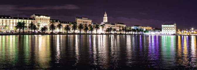 Split, Croatia at night. Long exposure photo with many lights. Bell tower of Saint Dominus cathedral seen above the buildings.