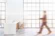© ImageFlow - Man walking in white kitchen with bar