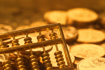 Wall Mural - A gold abacus was placed on the background of the pile of COINS