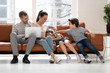 © fizkes - Happy family with two children having good time using laptop.