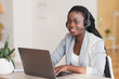 © Prostock-studio - African female customer support operator wearing headset and working on laptop
