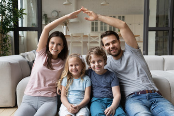 Wall Mural - Parents making shape of house roof over head of children