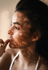 Wall Mural - portrait of a model on a sunny day shadows fall on the face and create a beautiful picture