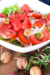 Wall Mural - lettuce, tomato and walnut salad diet and food concept