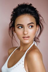 Wall Mural - portrait of beautiful model on a pink background in the studio