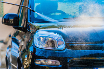 Wall Mural - Car going through an automated car wash machine