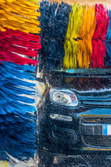 Wall Mural - Car going through an automated car wash machine