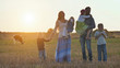 © Довидович Михаил - A large family goes on the field in the village during sunset.