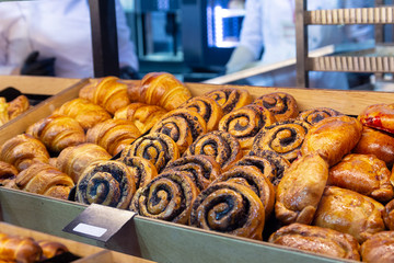 Assortment of delicious freshly baked sweet and puff pastry for sale on counter of shop, grocery, market, cafe or bakery.