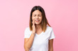 © luismolinero - Young woman over isolated pink background with toothache