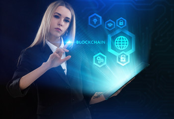 Business, Technology, Internet and network concept. Young businessman working on a virtual screen of the future and sees the inscription: Blockchain