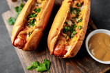 Fototapeta Tęcza - french hot dogs baked with cheese and mustard on a stone background